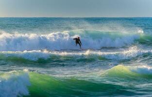 Surfer Riding big glassy waves photo