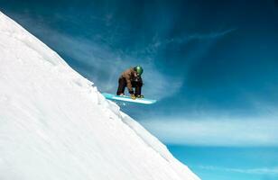 Active man snowboarding photo