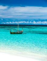 Little fishing boat in blue sea photo