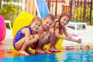 contento niños cerca el piscina foto