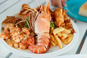 Tasty baked shrimps and lobster photo