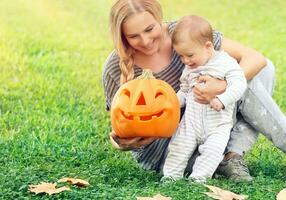 Happy mother with baby in Halloween holiday photo