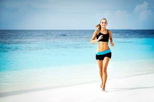 Woman running on the beach photo