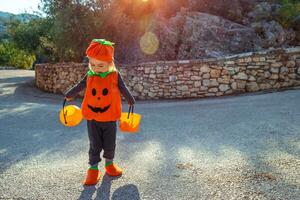 Baby in the costume celebrates Halloween photo