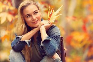 Beautiful woman in autumn park photo