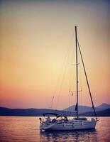 Sailboat in sunset light photo