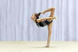 Little gymnast performing photo