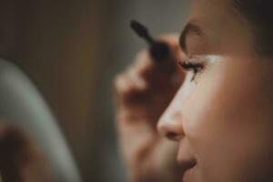 Woman doing her makeup at home photo