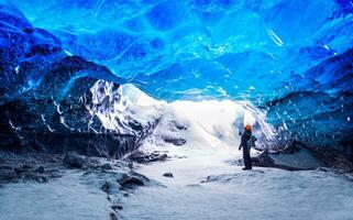 Traveler in ice cave photo