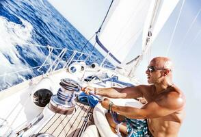 Handsome man working on sailboat photo