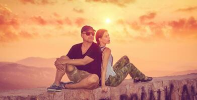 Beautiful couple enjoying sunset photo