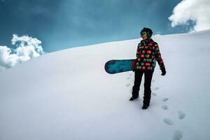 Girl snowboarder enjoys winter sport photo