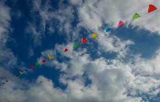 Colorful triangle flags in the sky photo