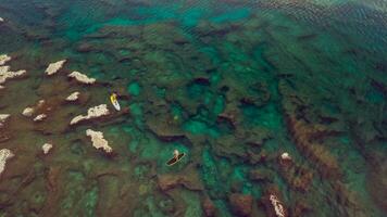 Arial shot of two man riding on sup photo