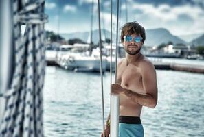 Sexy man on sailboat photo