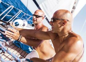 Sailors working on sailboat photo