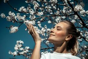 Enjoying aroma of blooming tree photo