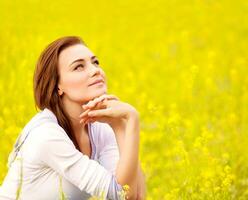 Cute female on yellow floral field photo