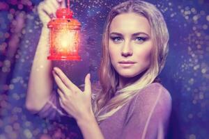 Beautiful woman with glowing lantern photo