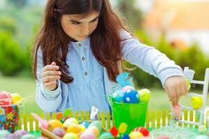 Nice girl playing with Easter eggs photo