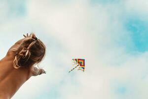 Happy child launches a kite photo