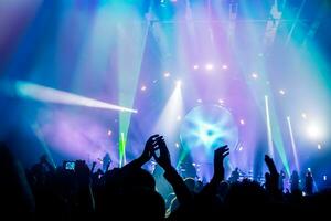 Concert background with dancing crowd photo