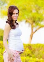 Expectant woman in spring park photo