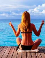 Yoga exercise on seashore photo