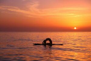 Woman trainings on the beach photo