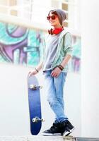 Cute teen boy with skateboard photo