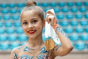 Happy gymnast received a gold medal photo