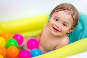 Baby boy taking bath photo