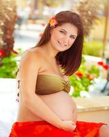 Pregnant woman on the beach photo