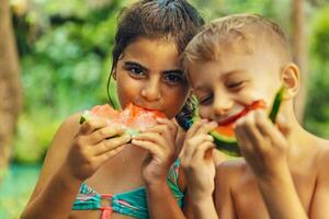 Happy friends eating watermelon photo