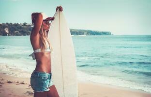 Sportive woman with surfboard photo