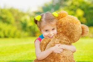 Happy girl with soft toy photo