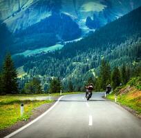 Group of bikers in mountains photo