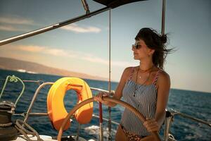Beautiful Woman Steering Sailboat photo