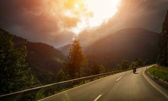 Motorcyclist in action in sunset light photo