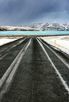 Road along frozen lake photo