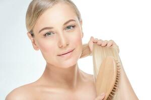 Gentle female combing her hair photo