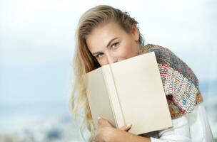 Nice female reads a book photo