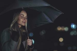 Calm female enjoying rainy night photo