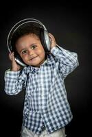 Cute little boy listens music photo