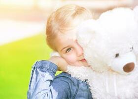 Happy girl with soft toy photo