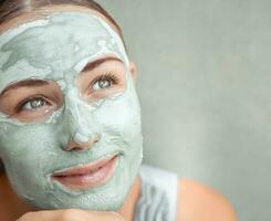 Beautiful girl doing facial mask photo