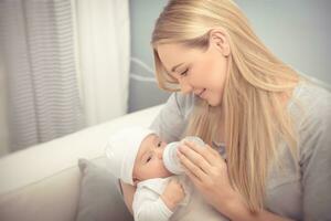 Mother feeding her baby photo