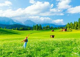 Happy traveler girl in mountainous valley photo