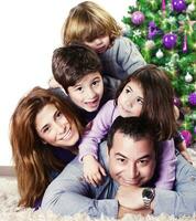 Happy family near Christmas tree photo