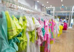 Bright colorful kids clothing in the store photo